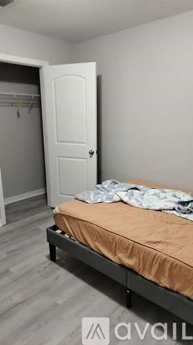 A bedroom with a bed, a wardrobe and a door.