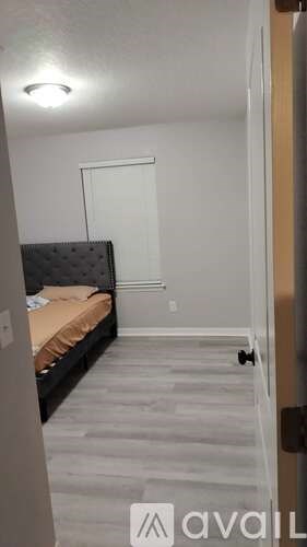 A bedroom with a bed and a door.