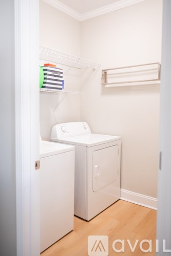 A small white laundry room with a washer and dryer.