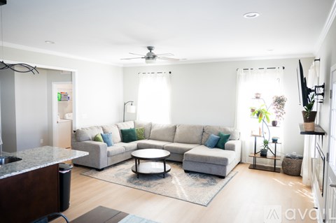 A living room with a grey couch and a coffee table.