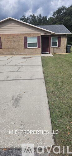 A house with a brown brick exterior and a red door is for sale.
