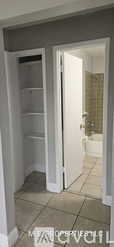 A bathroom with a walk-in shower and a pantry.