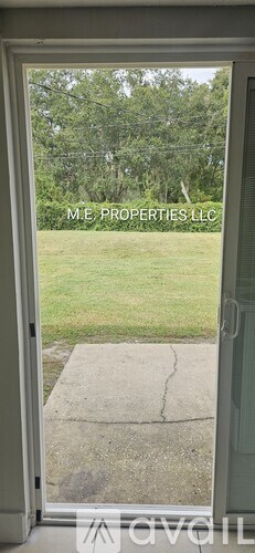 A view of a backyard through a glass door.
