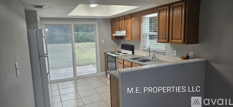 A kitchen with a refrigerator, microwave, and sink is available for rent.