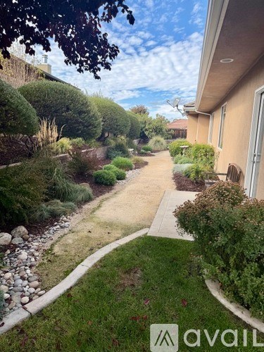 A residential area with a well-maintained garden and a pathway.