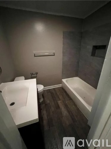 A bathroom with a white sink and a bathtub.