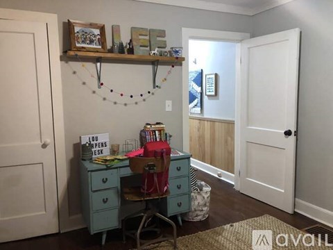 A room with a desk and a chair.