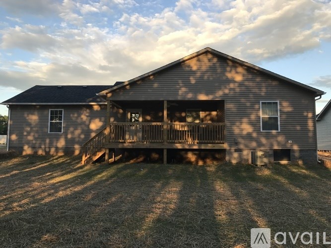 A house with a porch and a covered deck is available for sale.