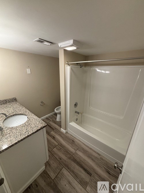 A bathroom with a sink, toilet, and bathtub.