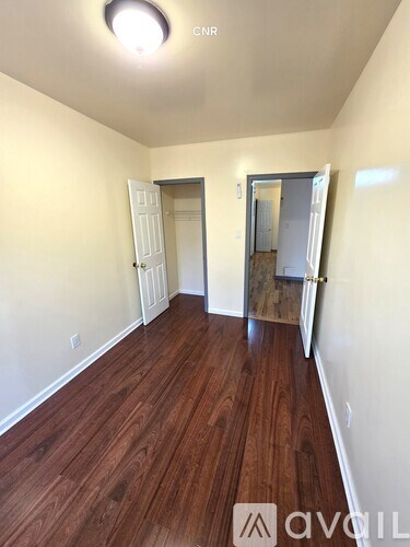 A room with wooden floors and white walls.