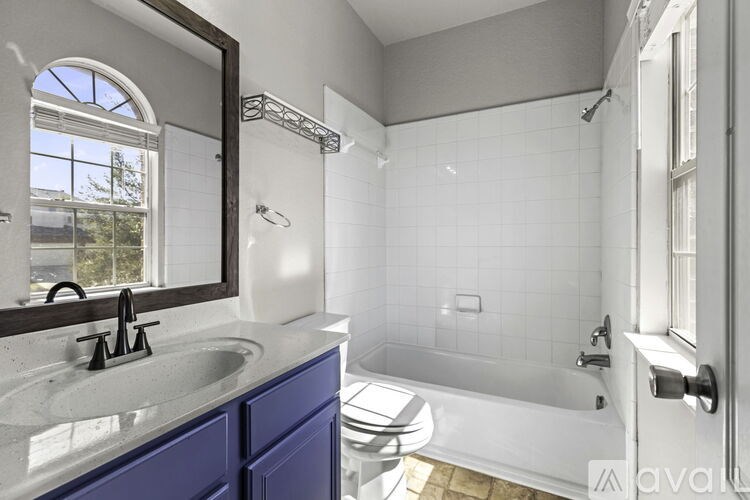 A bathroom with a sink, toilet, and bathtub.
