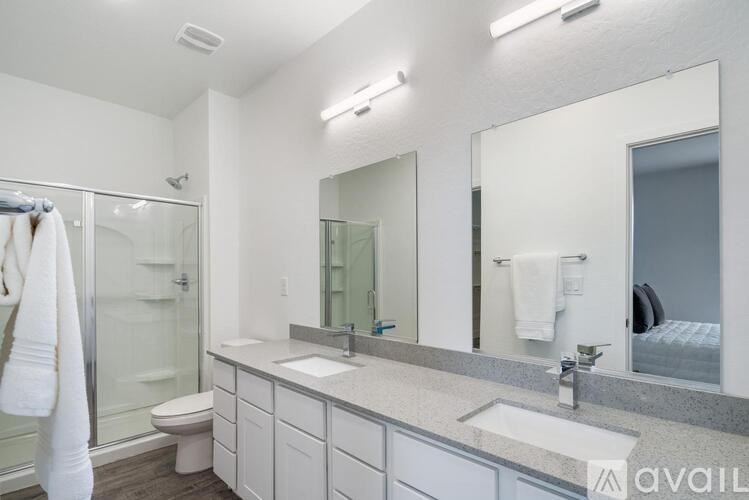 A bathroom with a white towel hanging on the glass door.