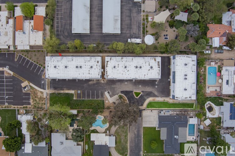 A bird's eye view of a parking lot and buildings.