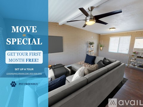 A living room with a grey sofa and a ceiling fan, advertising a move-in special.