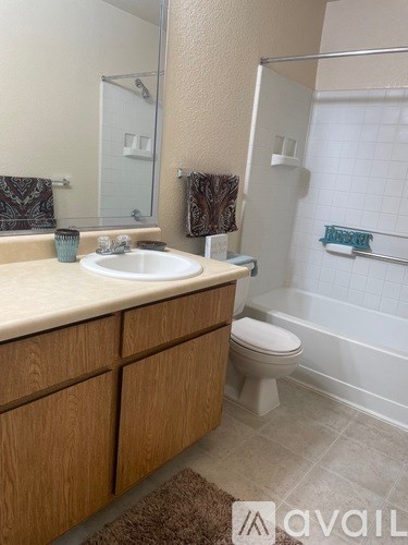 A bathroom with a sink, toilet, and shower.