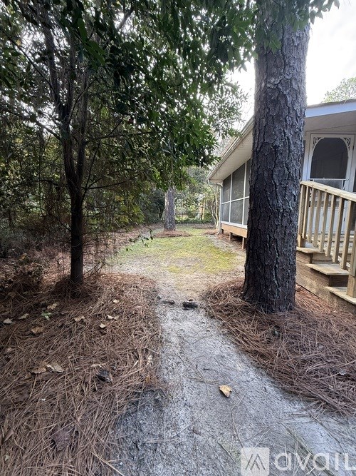 A tree is in front of a house.