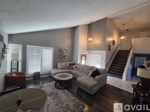A living room with a grey couch and a coffee table.