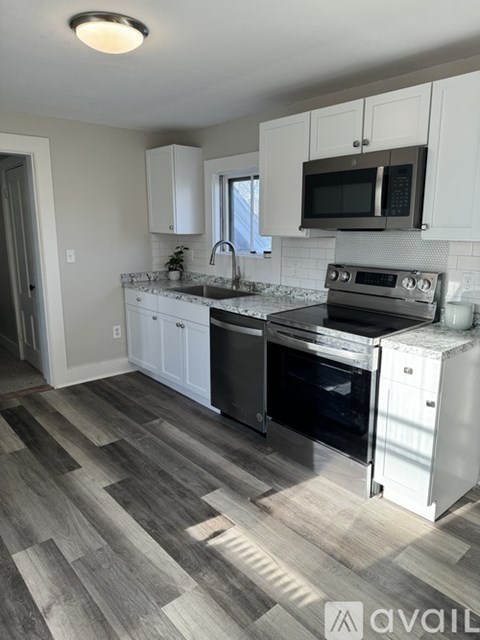 A kitchen with a stove top oven and microwave above it.