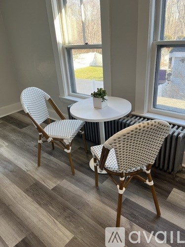 A room with a round table and two chairs.