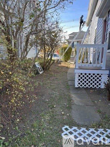 A man is painting the exterior of a house.