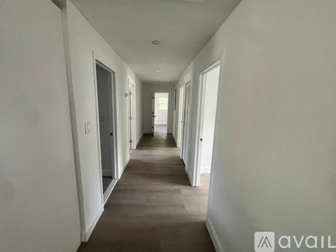 A long hallway with doors on both sides.