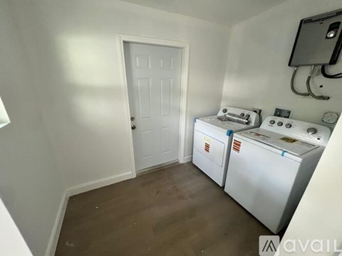 A small laundry room with a washer and dryer.