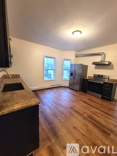 A kitchen with wooden floors and a window.