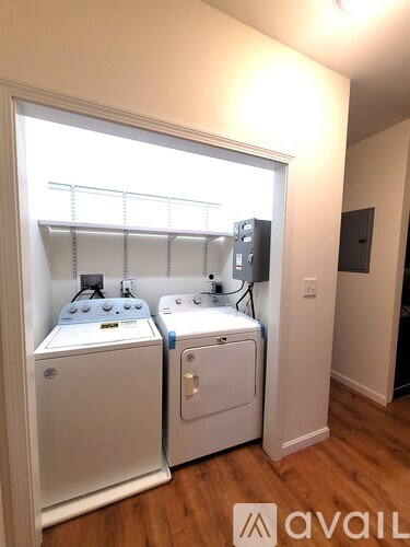 A small laundry room with a washer and dryer.