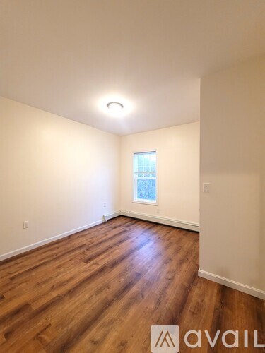 A room with wooden floors and a window.