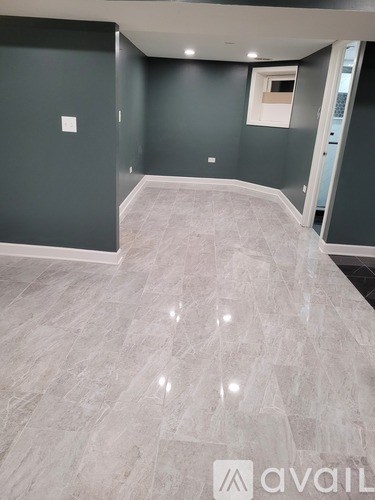 A kitchen with a black granite countertop and a stone backsplash.