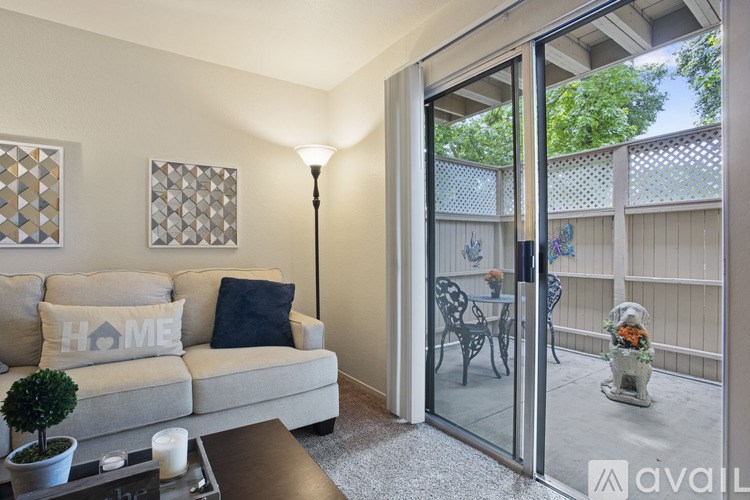 A living room with a couch and a lamp.