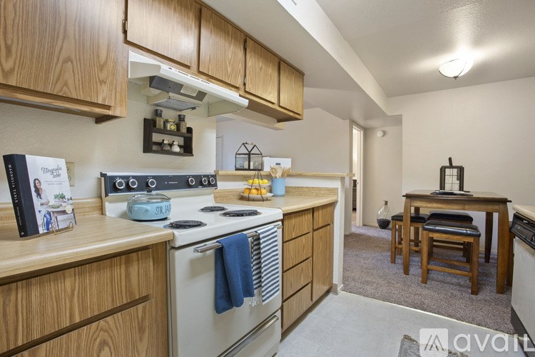 A kitchen with wooden cabinets and a stove top oven.