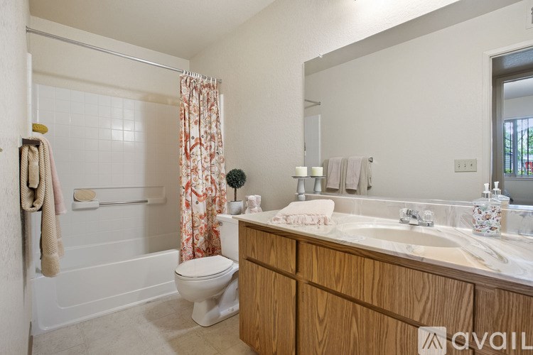 A bathroom with a toilet, sink, and shower.