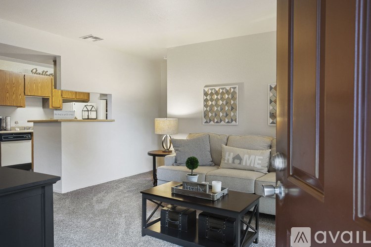 A living room with a couch, coffee table, and a lamp.