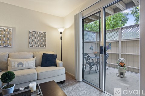 A living room with a couch and a lamp.
