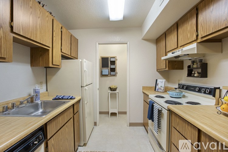 A kitchen with wooden cabinets and a white refrigerator.