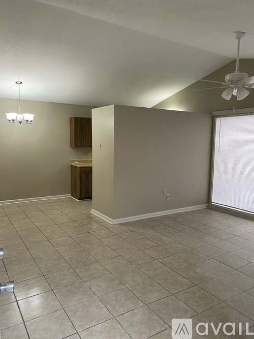 A room with a tile floor and a ceiling fan.