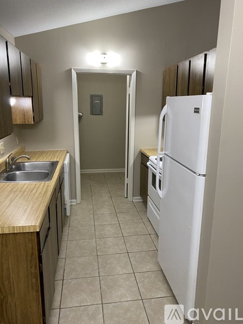A kitchen with a white refrigerator and a white oven.