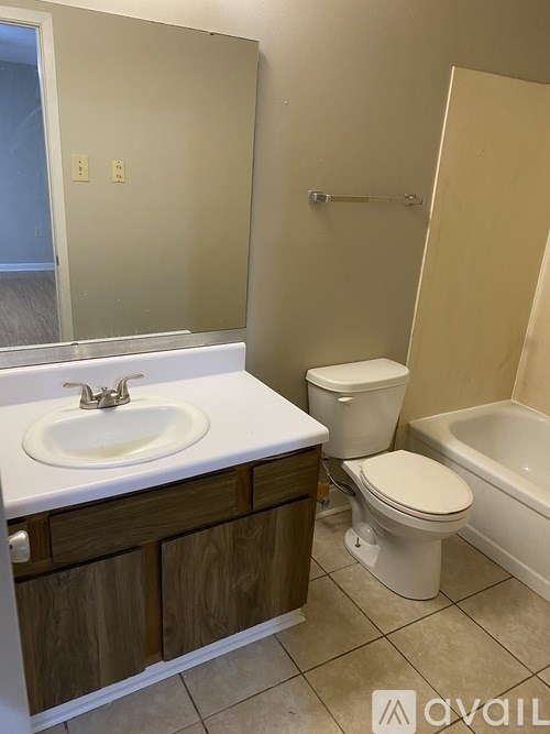 A bathroom with a sink, toilet and bathtub.