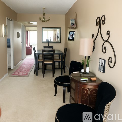 A dining room with a table set for four.