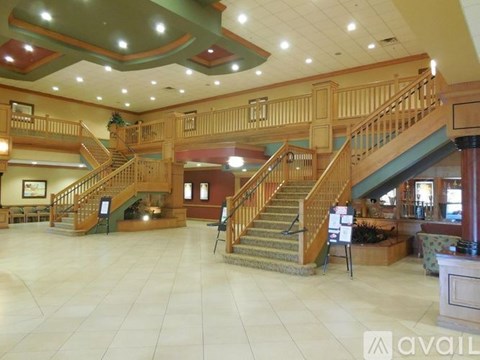 A large, open lobby with a staircase and a reception desk.