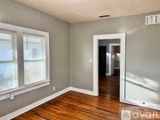A room with wooden floors and a white door.