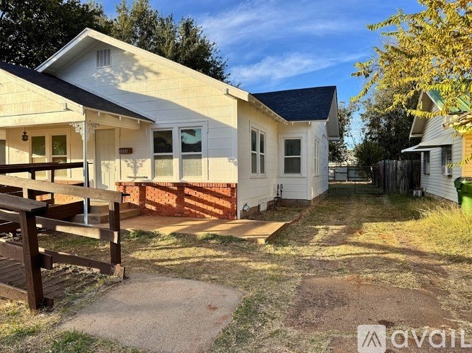 A house with a porch and a fence is for sale.