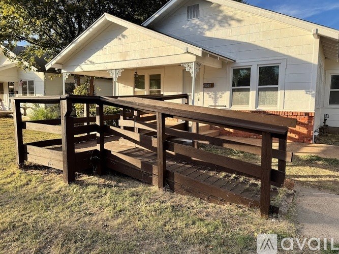 A wooden deck in front of a house.