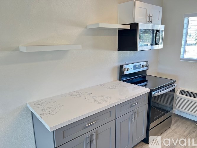 A kitchen with a white countertop and a black oven.