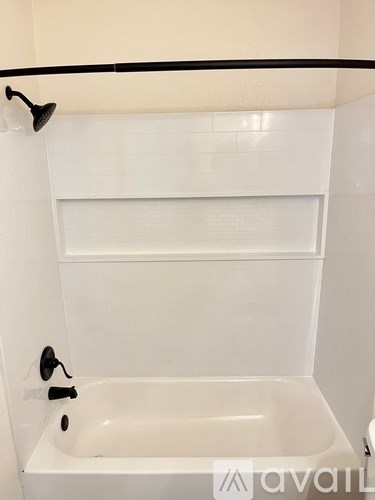 A white bathroom with a bathtub and a shower.