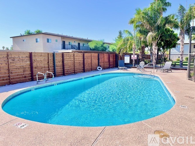 A small pool in a backyard with a fence around it.