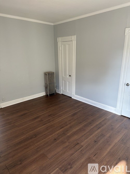 A room with wooden floors and white walls.