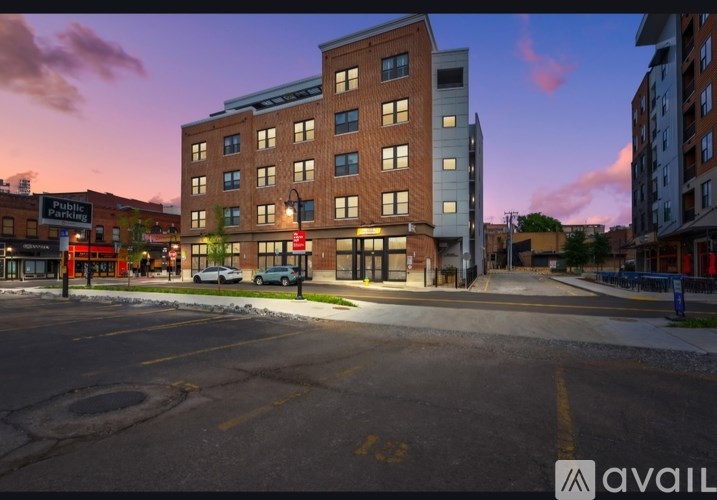 A street view of a building with a parking sign in front of it.