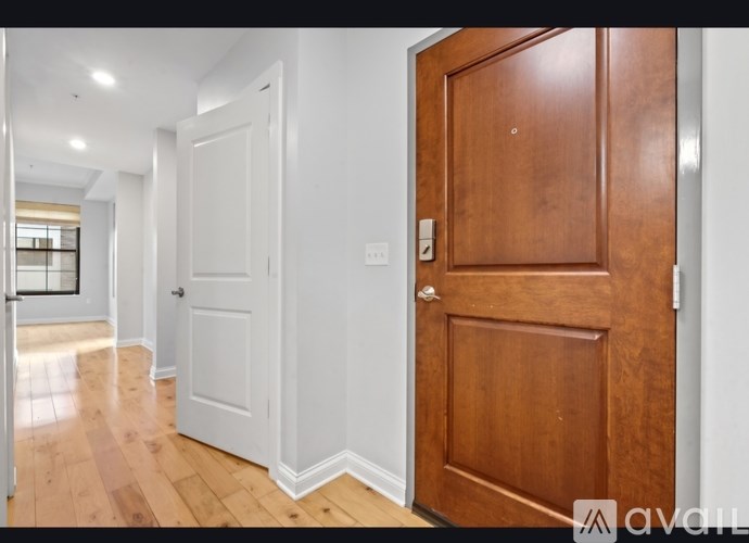 A room with a white door and a wooden door.